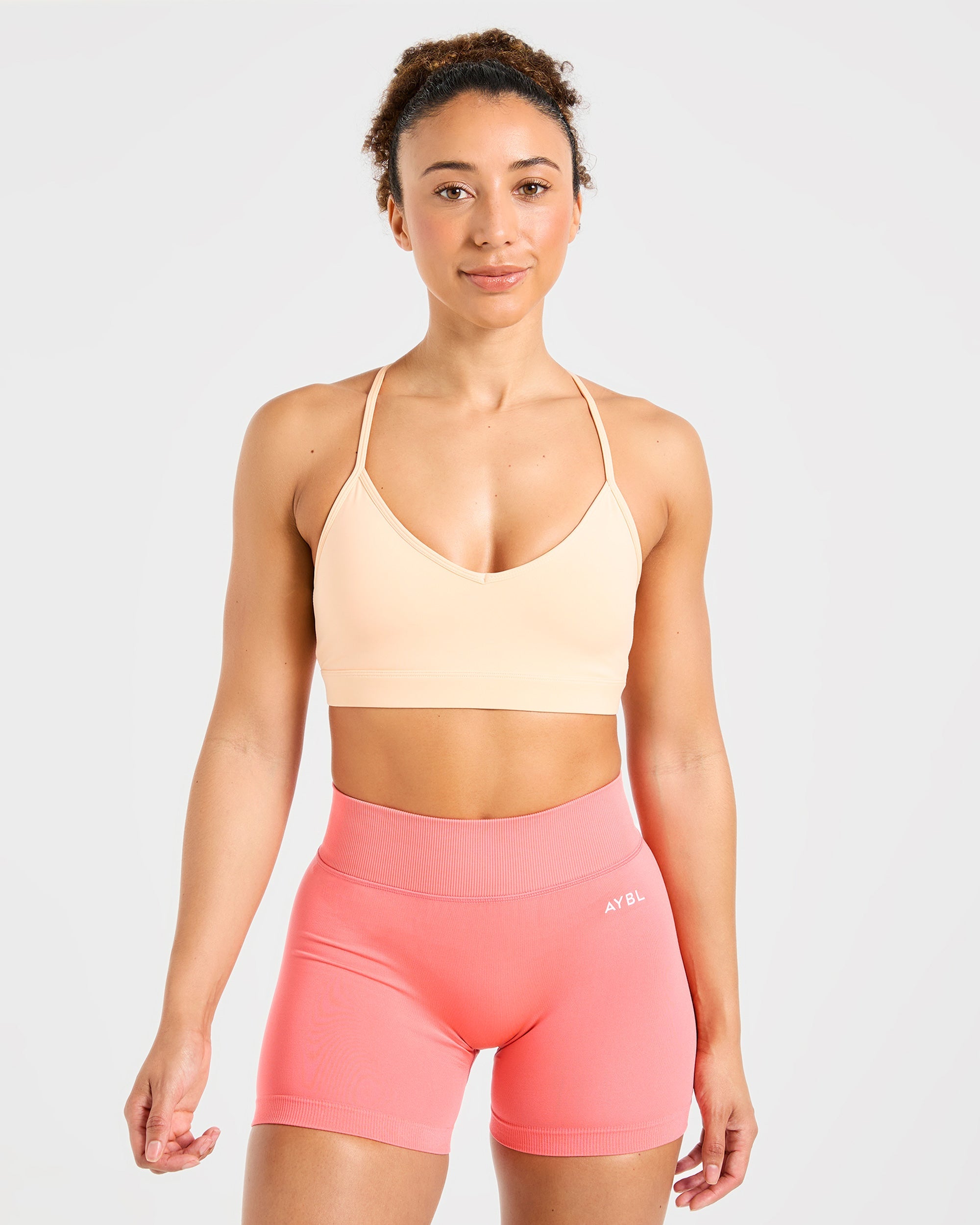 Sports Bra Essential con Cuello en V y Tirantes - Melocotón Pastel