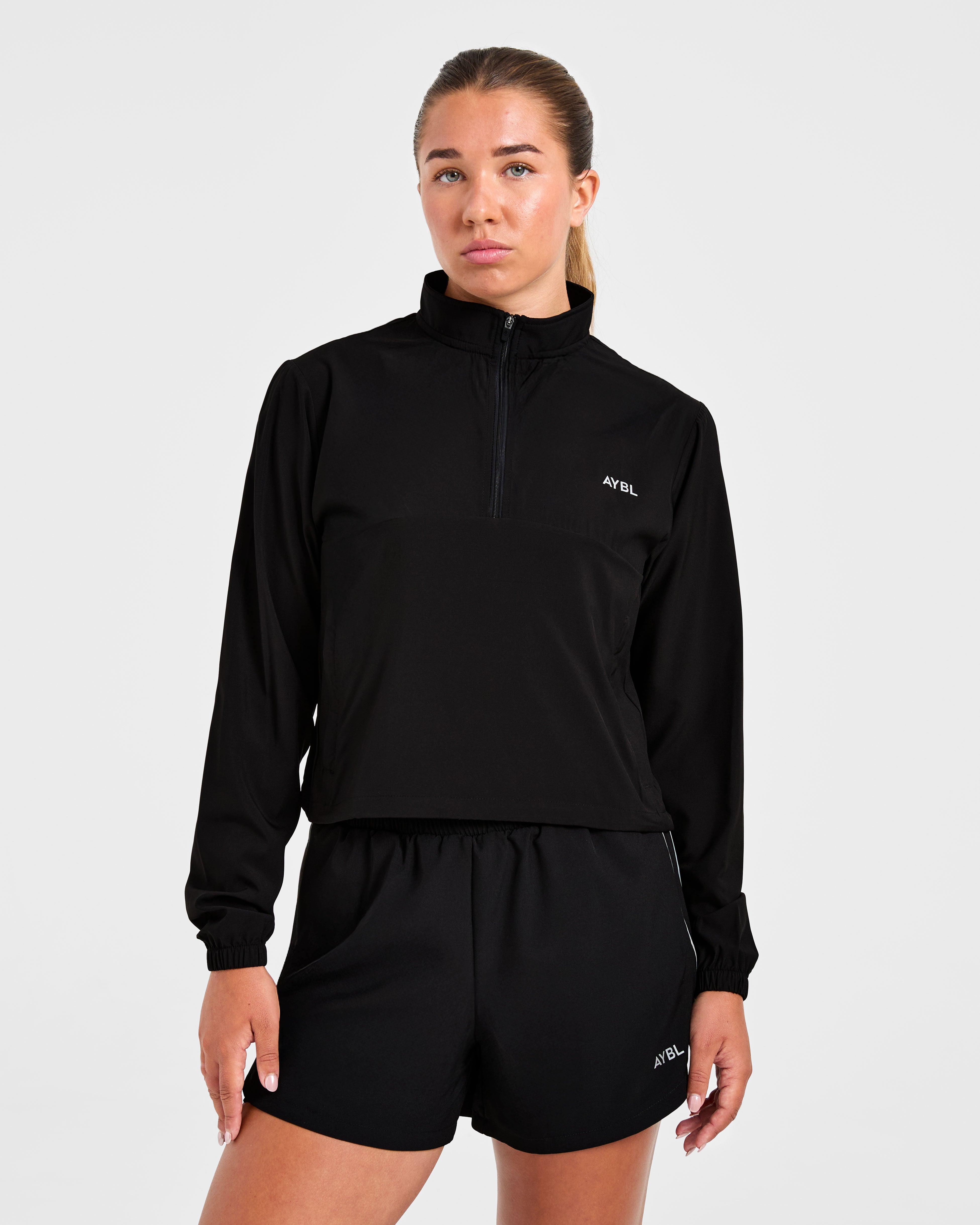Chaqueta de running con cremallera 1/2 - Negro