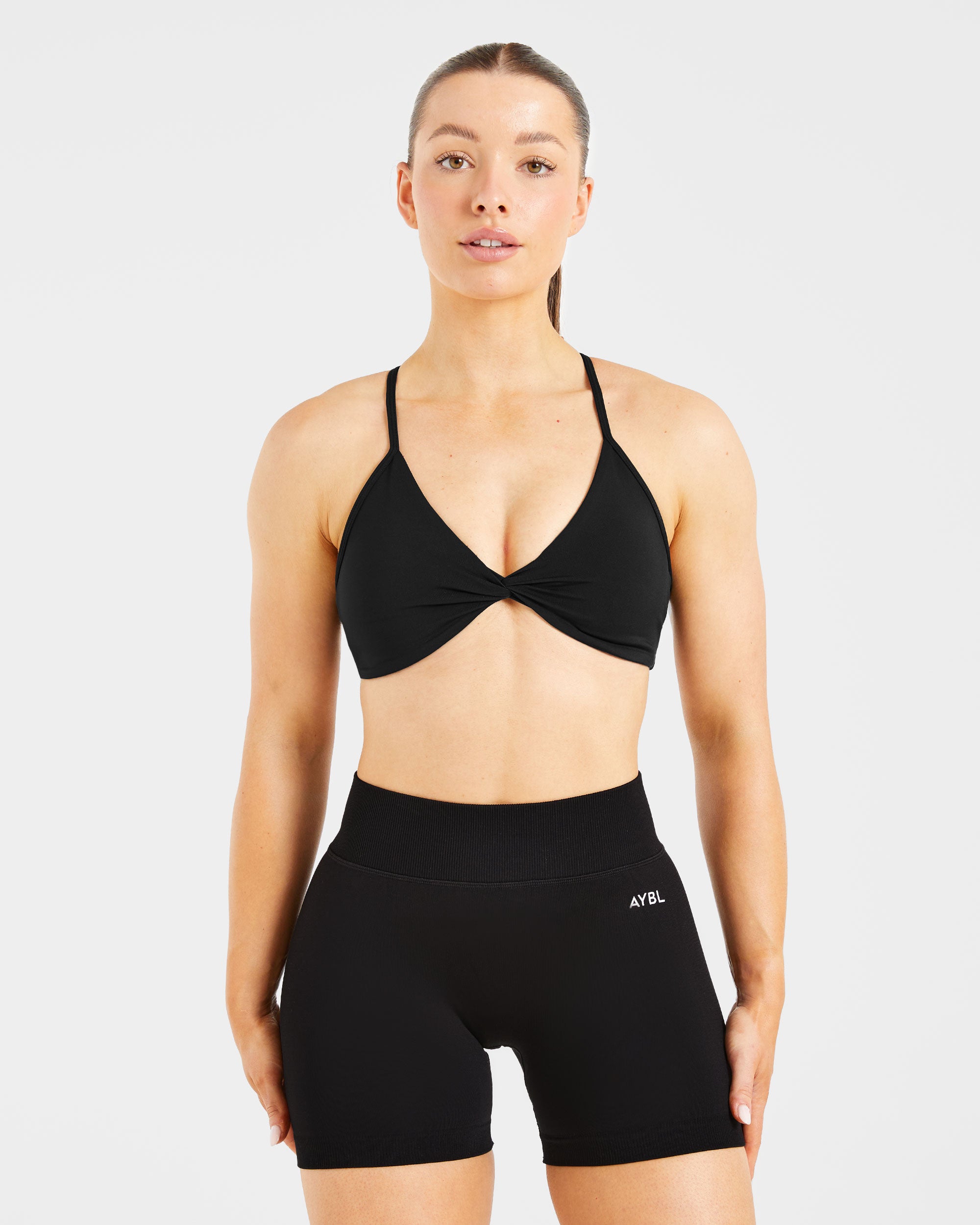 Sports Bra Essential Twist con Espalda Cruzada - Negro
